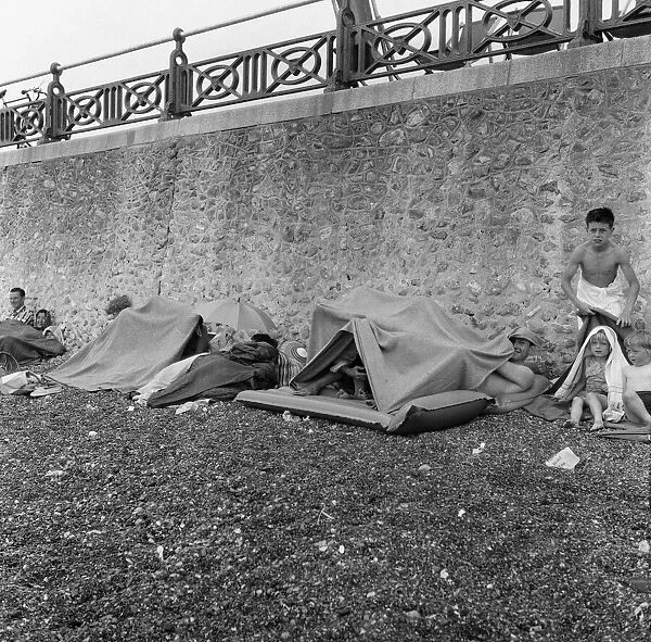Holidaymakers in the rain at Hove, East Sussex. 1st July 1961