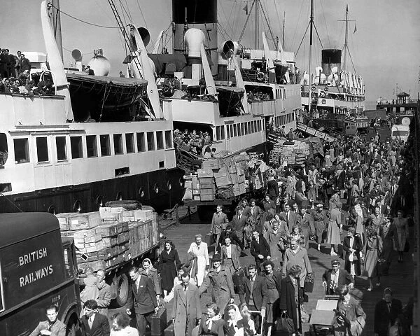 Holidaymakers returning from the Isle of Man make their way along Liverpool landing stage