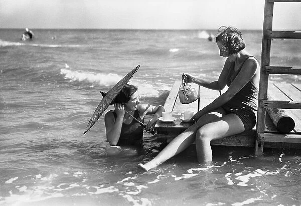 Holidaymakers take tea on a raft at Elmer Sands. August 1933 1115