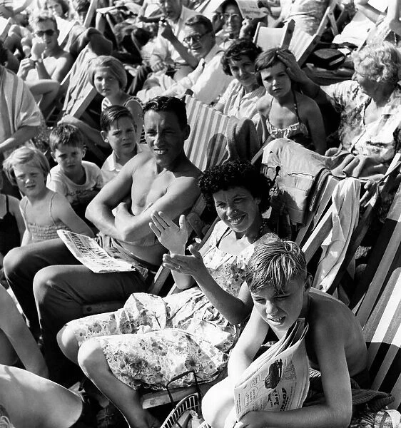 Holidays: Holiday makers Sunbathing whilst watching the Minor Beach Fashion Show