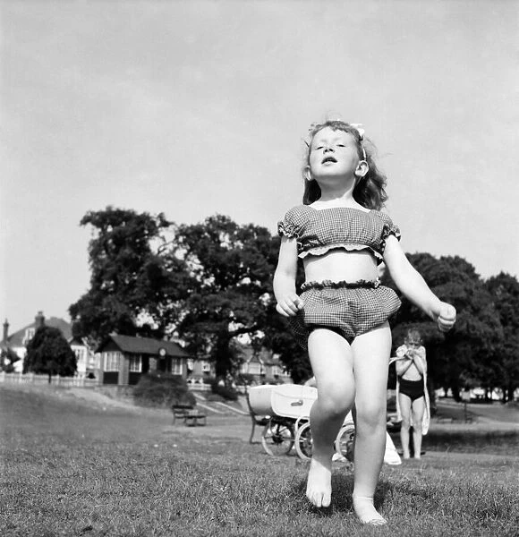 Holidays, little girl modelling swimsuit. June 1953 D3299-010