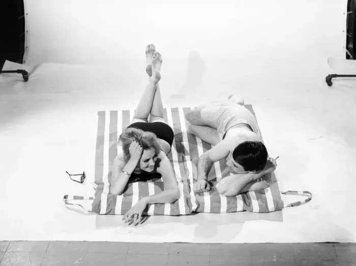 Framed Print : Holidays: Man and Woman demonstrating the beach bag that converts into a beach mat
