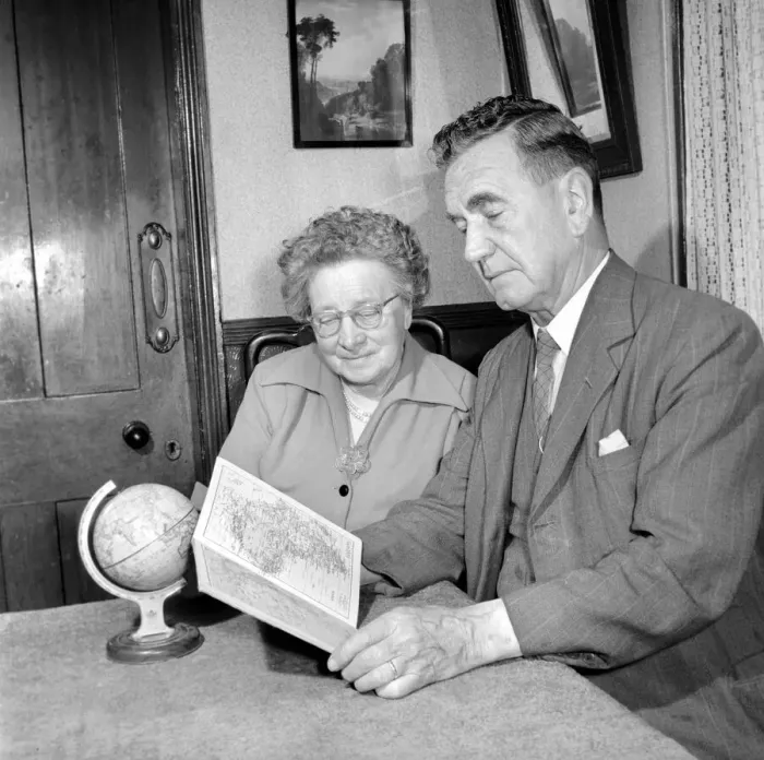 Framed Print : Holidays: Pensioners seen here looking at the globe deciding where to go to for their Framed Print : Holidays: Pensioners seen here looking at the globe deciding where to go to for their