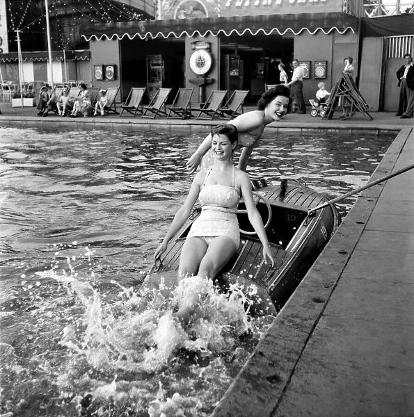 Holidays. Two young women enjoying the boating pool at the Festival pleasure gardens