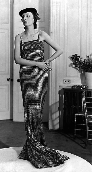 Holmes gown of striped Silver lame black hat trimmed velvet. October 1937 P008595