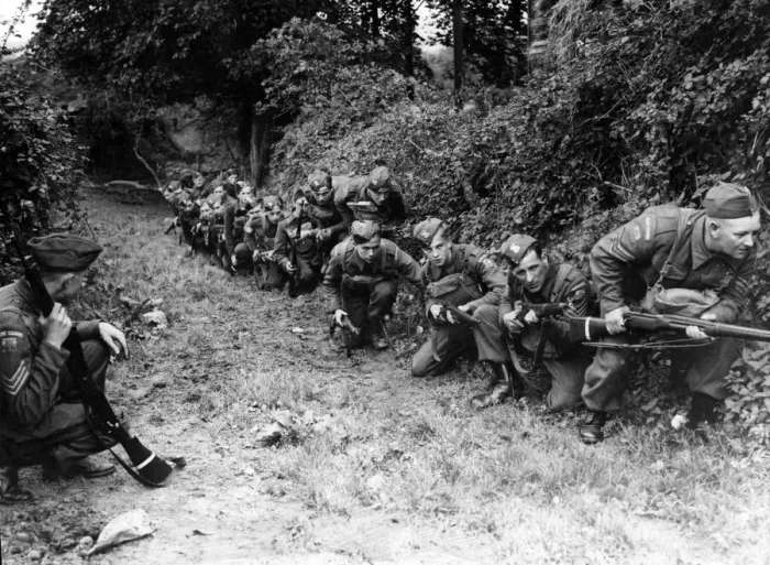 Framed Print : Home Guard camp near Cardiff. Men use the cover of a hedge before advancing against Framed Print : Home Guard camp near Cardiff. Men use the cover of a hedge before advancing against