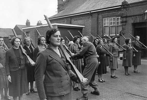A Home Guard Sergeant giving women instructions on holding rifles during a drill