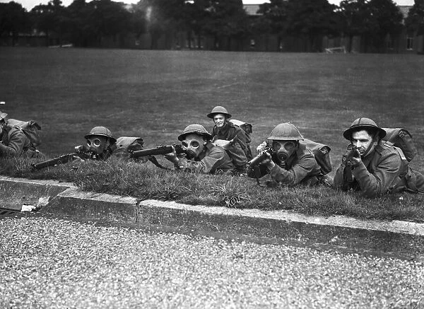 Home Guard taking rifle practice during a mock gas attack. Circa 1941