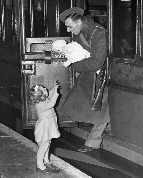 Home on Leave for Christmas. 1942. A soldier gives his daughter a doll