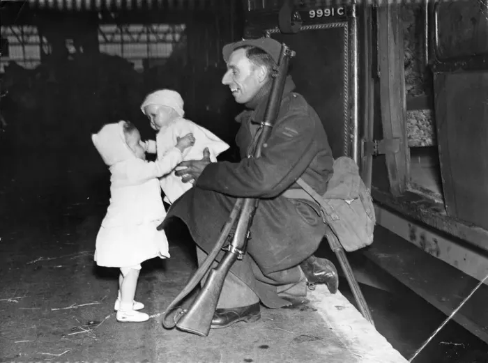 Framed Print : Home on Leave for Christmas. 1942. A soldier gives his daughter a doll Framed Print : Home on Leave for Christmas. 1942. A soldier gives his daughter a doll