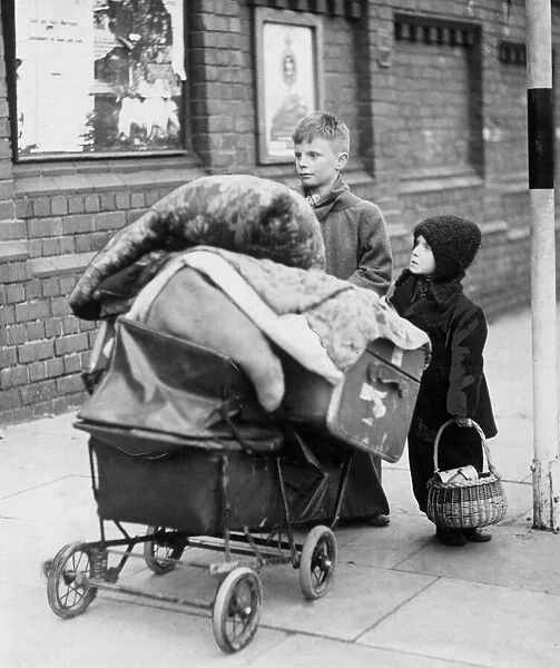 Homeless children with a pram of possessions. 22nd November 1940