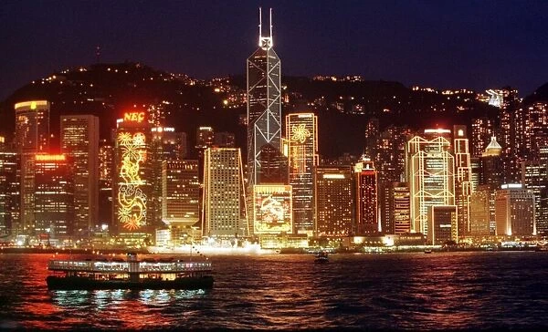 Hong Kong skyline seen from the harbour at night. The buildings are lit up for