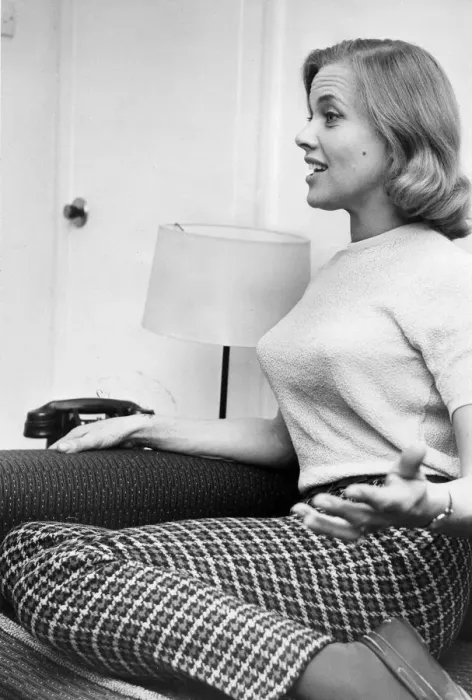 Framed Print : Honor Blackman interviewed kneeling on sofa wearing check slacks