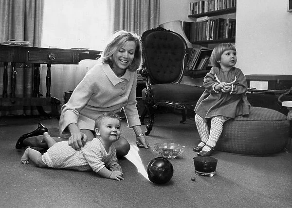 Honor Blackman playing with children Lottie and Barnaby at their home in London