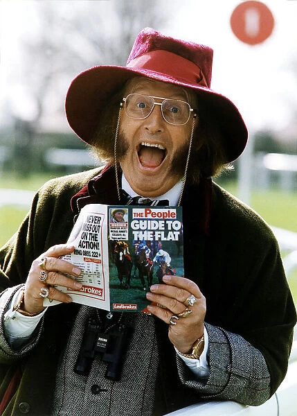 Horse Racing Journalist John McCririck, holding a copy of the People Guide to Flat Racing