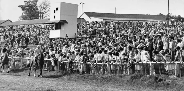 Framed Print : Horses and jockeys trot to the start watched by anxious race-goers at Hexham Racecourse Framed Print : Horses and jockeys trot to the start watched by anxious race-goers at Hexham Racecourse