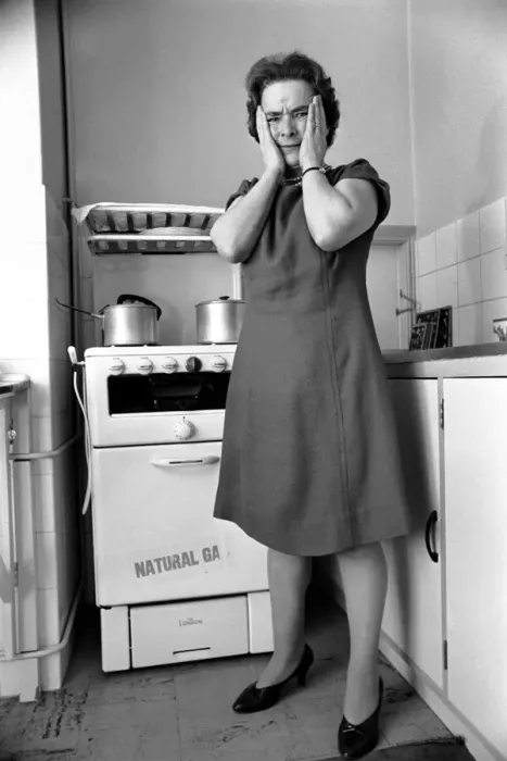 Framed Print : Household - Domestic Chores Cooking. A woman using her gas over in the kitchen of her Framed Print : Household - Domestic Chores Cooking. A woman using her gas over in the kitchen of her