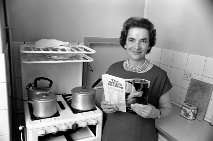 Framed Print : Household - Domestic Chores Cooking. A woman using her gas over in the kitchen of her Framed Print : Household - Domestic Chores Cooking. A woman using her gas over in the kitchen of her