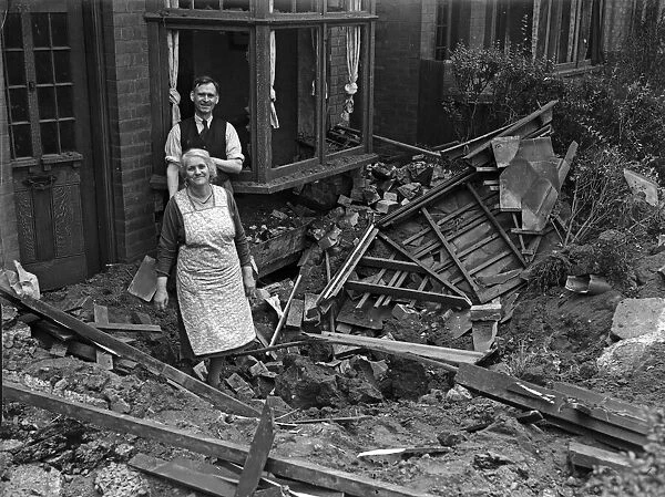 Householders examine the damage and crater to their Smallheath