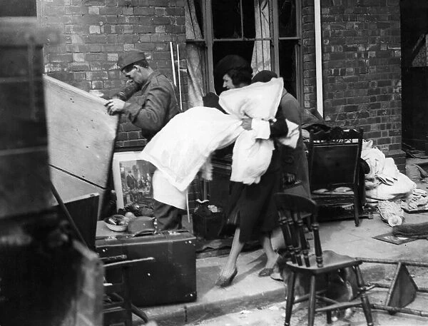 Householders salvaging good from a bombed area in South Wales. Circa 1941