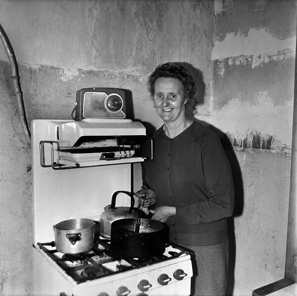 Housewife cooking dinner in her kitchen at home. December 1969 Z11805-001