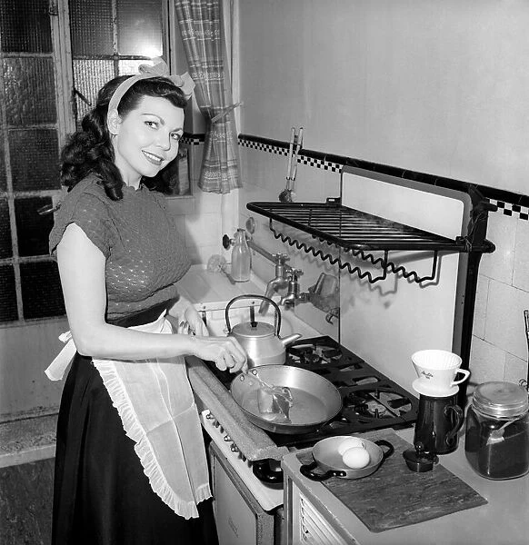 A Housewife cooking in the kitchen, 1957