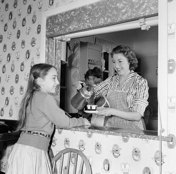 Housewife Vera Lynn at home with her daughter Virginia. 17th March 1957