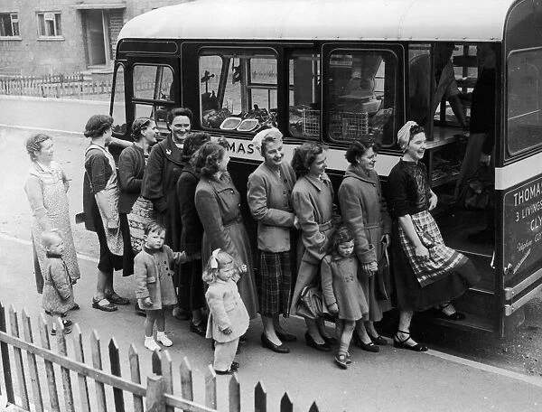 The housewives of Glasgows Drum Chapel housing project seen here queuing for