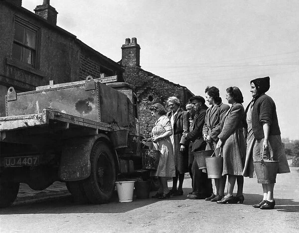 The housewives of Tottington queue up for their daily ration of water