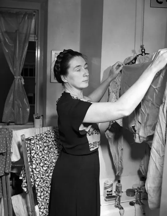 Framed Print : Housewives Washing Controversy Woman hanging up clothes to dry in her North Framed Print : Housewives Washing Controversy Woman hanging up clothes to dry in her North