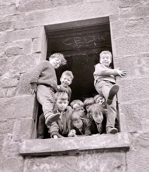 Housing slums in the Gorbals district of Glasgow where children play in the windows of