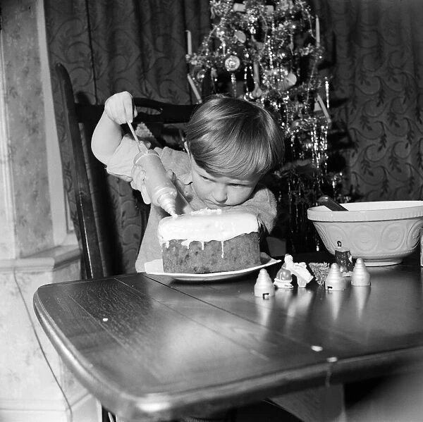 Howard Stanton Bottomley, 5, of Manchester having a go at icing a Christmas cake