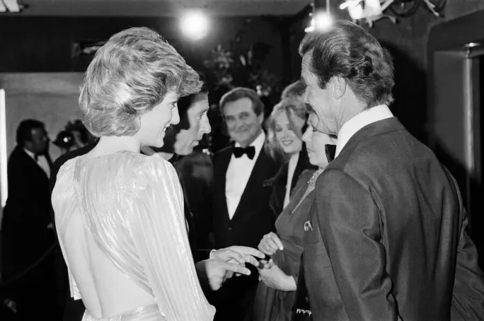 Framed Print : HRH The Princess of Wales, Princess Diana talking with lead actor Roger Moore