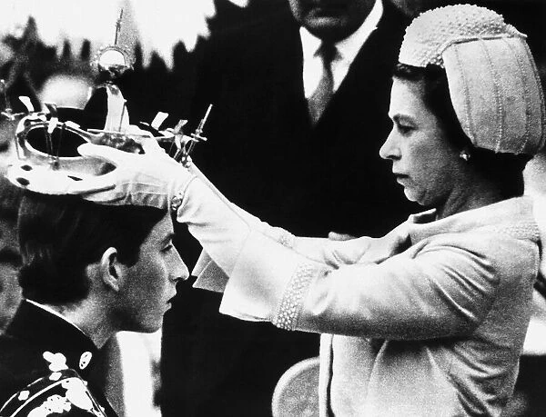 HRH Queen Elizabeth II places the crown on the head of Prince Charles in July 1969