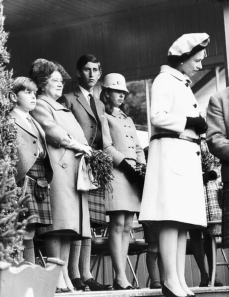 HRH Queen Elizabeth II standing with her children Prince Charles