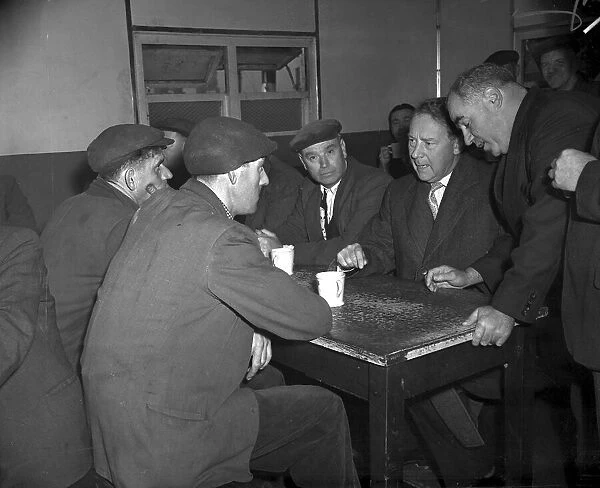 Hugh Gaitskell, MP, 1958 talks with Liverpool dockers over a mug of tea in Gladstone Dock