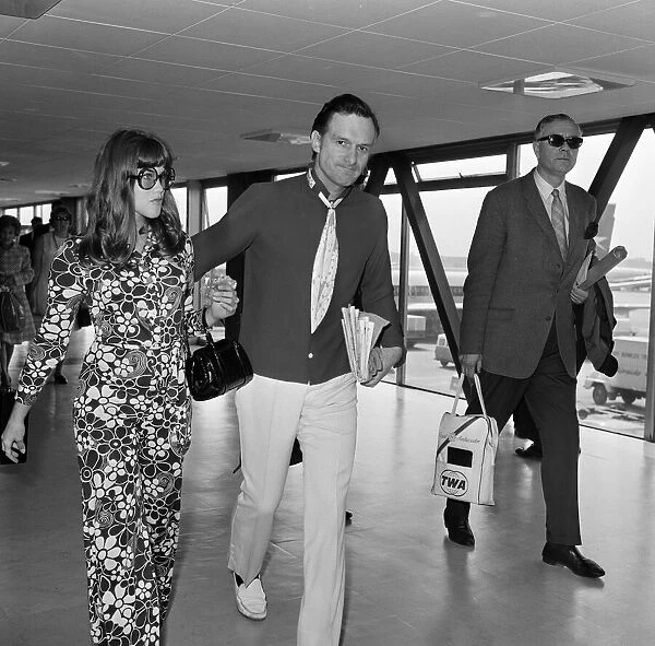 Hugh Hefner pictured with his girlfriend Barbi Benton at the airport. 6th September 1969