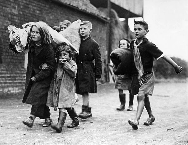 Hull children carrying their belongings on their backs following an air raid on the city