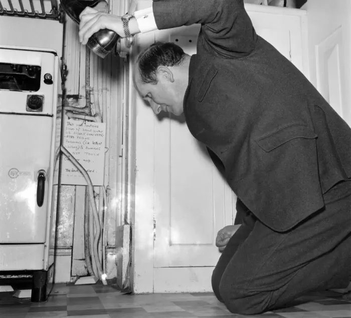 Framed Print : Humour: The Rev Brian Bason shoe in hand prepares to make a kill in his battle with Framed Print : Humour: The Rev Brian Bason shoe in hand prepares to make a kill in his battle with