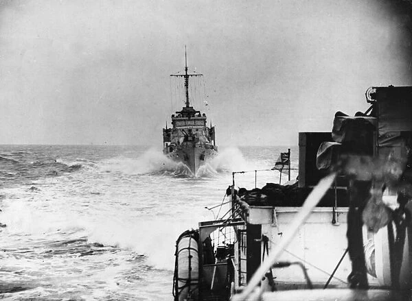 Hunt Class destroyer HMS Southdown of the Royal Navy throwing up a bow wave as follows