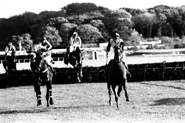 Framed Print : Over the last hurdle safely Narvik (right) is pushed out by Denis Atkins to shrug off