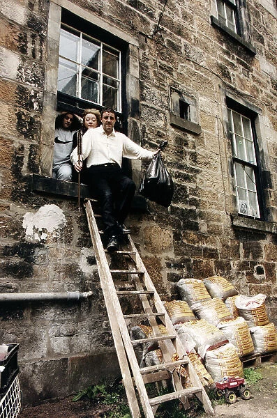 Iain McColl actor with family climbing out window down ladders
