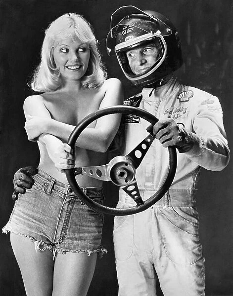 Ian Ashley and Angela Jay pose together holding a steering wheel