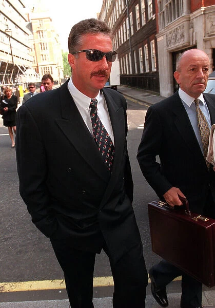 Ian Botham arrives with his lawer at the High Court for his libel case against Imran Khan
