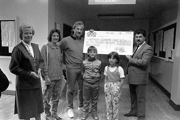 Ian Botham hands over a cheque for £15, 000, raised by readers of the Sunday Sun