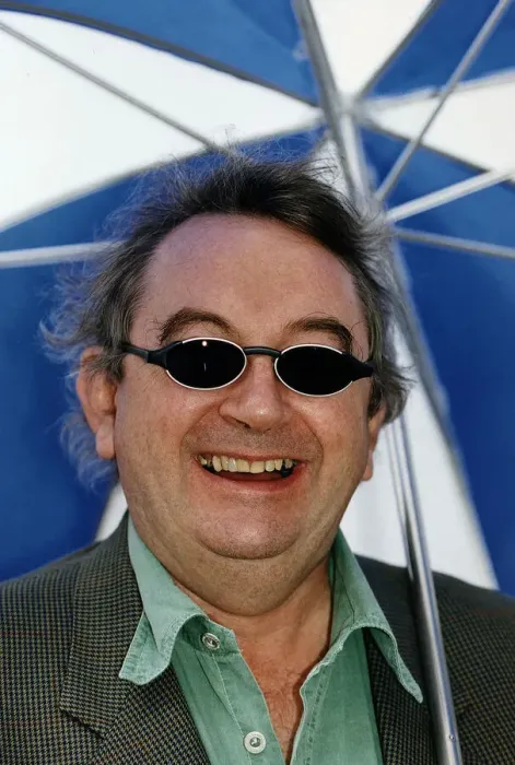 Framed Print : Ian McCaskill wearing a pair of BHS Ultraviolet Protection Sunglasses holding umbrella