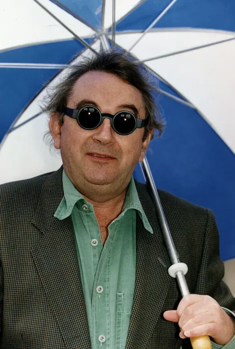 Framed Print : Ian McCaskill wearing a pair of Debenhams Mondo Sunglasses holding umbrella Framed Print : Ian McCaskill wearing a pair of Debenhams Mondo Sunglasses holding umbrella