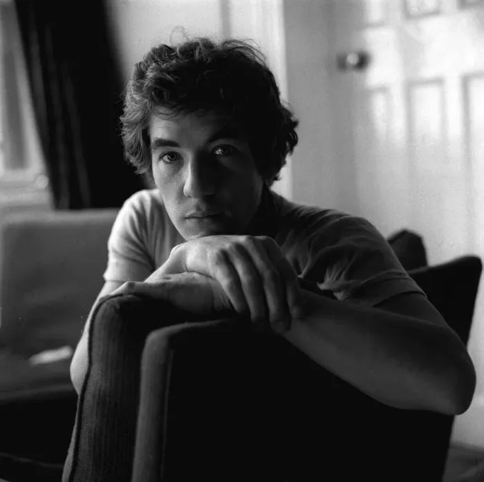 Framed Print : Ian McKellen actor sitting on chair arm over the back hands together Framed Print : Ian McKellen actor sitting on chair arm over the back hands together