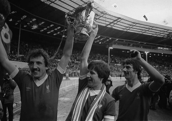 Ian Rush right with Alan Kennedy and Ronnie Whelan of Liverpool with the League Cup after