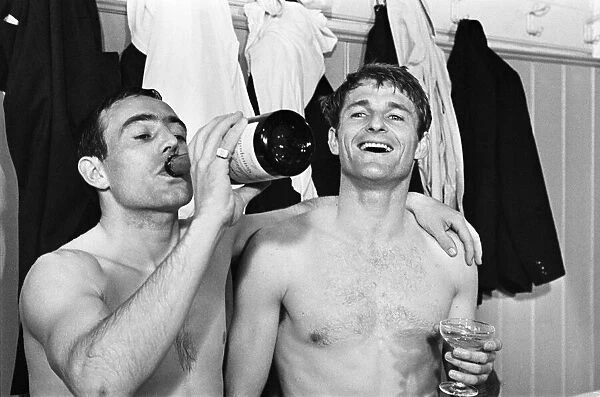 Ian St John of Liverpool drinks champagne 1966 with Roger Hunt after winning